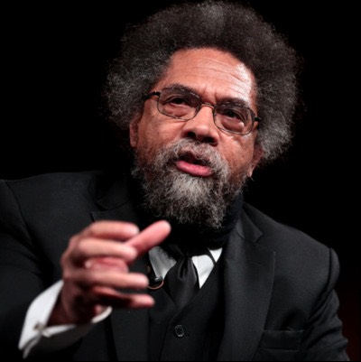 Image of a man wearing a suit and giving a speech on a stage
