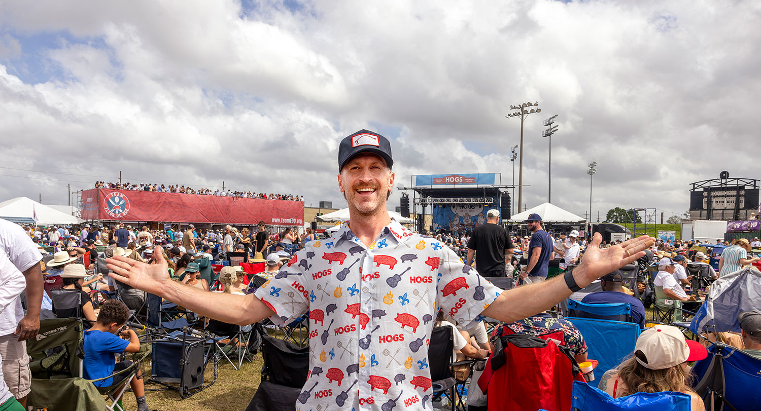 Alumnus Becker Hall with his philanthropic festival, Hogs for the Cause, in the background..