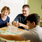 Mark Cox playing a board game with family