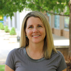 A woman standing in an outdoor area. 