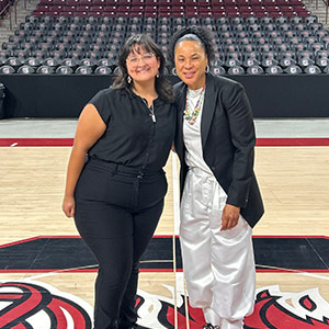 Nicole Gomez Peele poses with Dawn Staley on the USC basketball court.